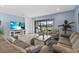 A cozy living room featuring comfortable furnishings, a mounted TV, and a view of the backyard at 9291 Starry Night Ave, Sarasota, FL 34241