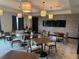 Meeting room features tables, chairs, and large screen, great for meetings and coworking at 9291 Starry Night Ave, Sarasota, FL 34241