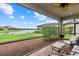 This screened patio offers a tranquil view of the lake, seating area, and beautiful scenery at 9291 Starry Night Ave, Sarasota, FL 34241