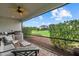 Relaxing screened patio features an outdoor kitchen, ceiling fan, and expansive backyard views at 9291 Starry Night Ave, Sarasota, FL 34241