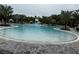 Large outdoor pool surrounded by palm trees and lounge chairs, ideal for swimming and relaxation at 9291 Starry Night Ave, Sarasota, FL 34241