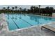 Swimming pool with lane dividers and lounge chairs, designed for exercise and relaxation at 9291 Starry Night Ave, Sarasota, FL 34241