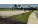 Sand volleyball court with a net, surrounded by grass and landscaping in a recreational area at 9291 Starry Night Ave, Sarasota, FL 34241
