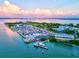 Stunning aerial view of a marina surrounded by water and a picturesque cityscape at sunset at 1000 Longboat Club Road # 1105, Longboat Key, FL 34228