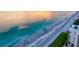 Stunning aerial view of a pristine beach, ocean, and coastal building perfect for vacation stays at 1000 Longboat Club Road # 1105, Longboat Key, FL 34228