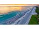 Beautiful aerial view of the beach, ocean, and golden sunset, perfect for relaxing and enjoying the scenery at 1000 Longboat Club Road # 1105, Longboat Key, FL 34228