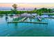 Beautiful aerial view of a waterfront restaurant with docks and serene blue waters at 1000 Longboat Club Road # 1105, Longboat Key, FL 34228