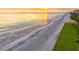 Beautiful aerial view of the beach, ocean, and golden sunset, perfect for relaxing and enjoying the scenery at 1000 Longboat Club Road # 1105, Longboat Key, FL 34228