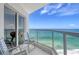 Relaxing balcony with comfortable chairs, a view of the ocean, and glass railings at 1000 Longboat Club Road # 1105, Longboat Key, FL 34228