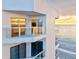 Beachside condo balcony with glass railings offering stunning ocean views and sunset reflections at 1000 Longboat Club Road # 1105, Longboat Key, FL 34228
