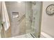 Modern bathroom with a glass shower, pebble floor and neutral colored stone at 1000 Longboat Club Road # 1105, Longboat Key, FL 34228