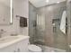 Bathroom features a glass enclosed shower with gray tile and pebble-style flooring at 1000 Longboat Club Road # 1105, Longboat Key, FL 34228