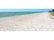 A serene beach view with clear water and white sand at 1000 Longboat Club Road # 1105, Longboat Key, FL 34228
