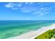Scenic beach view of pristine white sand and emerald waters under a bright, sunny sky at 1000 Longboat Club Road # 1105, Longboat Key, FL 34228