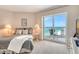 Bright bedroom with a comfortable bed and a view of the Gulf from the balcony at 1000 Longboat Club Road # 1105, Longboat Key, FL 34228
