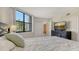 Comfortable bedroom featuring a large window with natural light and a view of the lush greenery outside at 1000 Longboat Club Road # 1105, Longboat Key, FL 34228