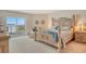Relaxing bedroom with a balcony overlooking the beach and a comfortable bed at 1000 Longboat Club Road # 1105, Longboat Key, FL 34228