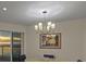 Dining room with contemporary chandelier and expansive ocean view through sliding glass door at 1000 Longboat Club Road # 1105, Longboat Key, FL 34228