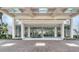 Elegant building entrance with glass doors, marble floors, and well-manicured landscaping at 1000 Longboat Club Road # 1105, Longboat Key, FL 34228