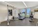 Fitness center equipped with treadmill, weight machines, and scenic views through expansive windows at 1000 Longboat Club Road # 1105, Longboat Key, FL 34228