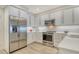 This contemporary kitchen features white cabinets, stainless steel appliances, and a stylish backsplash at 1000 Longboat Club Road # 1105, Longboat Key, FL 34228