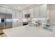 Bright white kitchen featuring quartz countertops, modern appliances, and decorative backsplash at 1000 Longboat Club Road # 1105, Longboat Key, FL 34228