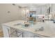 Modern kitchen island with seating, stainless steel appliances, and sleek white cabinets at 1000 Longboat Club Road # 1105, Longboat Key, FL 34228