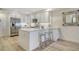 Modern white kitchen features sleek cabinetry, stainless steel appliances, and a stylish island at 1000 Longboat Club Road # 1105, Longboat Key, FL 34228
