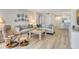Bright living room featuring modern furniture, decorative plates and flowers, and light wood floors at 1000 Longboat Club Road # 1105, Longboat Key, FL 34228