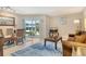 Cozy living area with dining set, couch, TV, and sliding doors leading to outdoor area at 1000 Longboat Club Road # 1105, Longboat Key, FL 34228