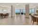 Spacious community lounge featuring tables, seating and views of the ocean through expansive windows at 1000 Longboat Club Road # 1105, Longboat Key, FL 34228