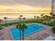 Swimming pool overlooking the ocean, view of palm trees and beach at 1000 Longboat Club Road # 1105, Longboat Key, FL 34228