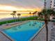 Sparkling blue pool, palm trees, and beach at beachfront condo at 1000 Longboat Club Road # 1105, Longboat Key, FL 34228