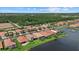 An aerial view of waterfront homes with lush greenery, offering serene lake views and meticulously maintained landscapes at 11550 Blackfin St, Venice, FL 34292