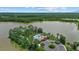Beautiful aerial view showcases a lakefront community with a swimming pool, mature trees, and well-maintained grounds at 11550 Blackfin St, Venice, FL 34292