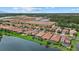 Aerial shot of lakeside homes with screened pools, showcasing community living surrounded by nature at 11550 Blackfin St, Venice, FL 34292