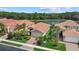 Aerial view of residential homes with terracotta tile roofs near a peaceful lake and lush greenery at 11550 Blackfin St, Venice, FL 34292