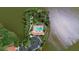 Overhead view features a resort-style community pool with cabanas, surrounded by a lake and meticulously landscaped grounds at 11550 Blackfin St, Venice, FL 34292