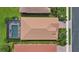 An aerial view of a well-maintained property with a screen-enclosed pool and landscaping at 11550 Blackfin St, Venice, FL 34292
