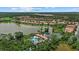 Expansive aerial view of a residential community featuring a large lake, pool, and lush green landscaping at 11550 Blackfin St, Venice, FL 34292