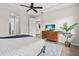 Bedroom with tray ceiling, light gray walls, and view of the water at 11550 Blackfin St, Venice, FL 34292