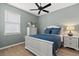 Bedroom with neutral walls, a ceiling fan, and natural light, creating a serene space for rest at 11550 Blackfin St, Venice, FL 34292