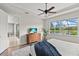 Serene bedroom with tray ceiling, a view of the water, and a flat screen TV at 11550 Blackfin St, Venice, FL 34292