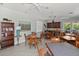 A community room offers tables, chairs, and a kitchenette creating a comfortable gathering space for residents at 11550 Blackfin St, Venice, FL 34292