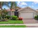 Attractive single-story home with a well-kept lawn, mature landscaping, and a brick paver driveway at 11550 Blackfin St, Venice, FL 34292