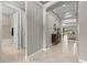 Hallway with neutral walls, tiled floor, and an arched entryway, seamlessly connecting the living spaces at 11550 Blackfin St, Venice, FL 34292