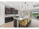 Modern kitchen with a large island, granite countertops, and stainless steel appliances at 11550 Blackfin St, Venice, FL 34292