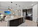 Open-concept kitchen with island, stainless appliances, and view into the living room at 11550 Blackfin St, Venice, FL 34292