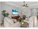 Light filled living room with contemporary decor and a ceiling fan, creating a comfortable and stylish space at 11550 Blackfin St, Venice, FL 34292