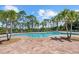 Community pool with a spacious deck and surrounded by lush landscaping, offering a relaxing outdoor space at 11550 Blackfin St, Venice, FL 34292